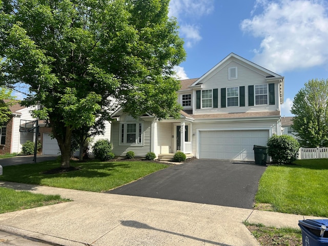 5966 Twin Pine Dr, New Albany, OH 43054 - view of front of home with asphalt driveway, an attached garage, and a front lawn