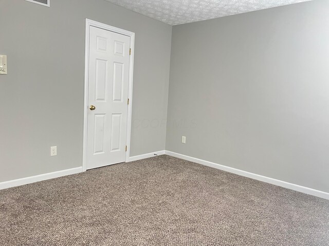5966 Twin Pine Dr, New Albany, OH 43054 - carpeted empty room featuring baseboards and a textured ceiling