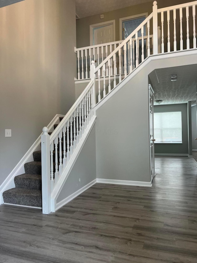 5966 Twin Pine Dr, New Albany, OH 43054 - staircase with wood finished floors and baseboards
