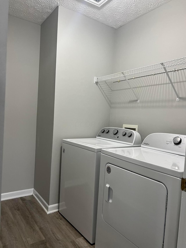 5966 Twin Pine Dr, New Albany, OH 43054 - laundry room featuring washing machine and dryer, wood finished floors, baseboards, and a textured ceiling