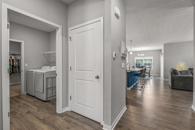 759 Abby Dr, Plain City, OH 43064 - washroom featuring washing machine and dryer, a chandelier, dark wood finished floors, baseboards, and a textured ceiling
