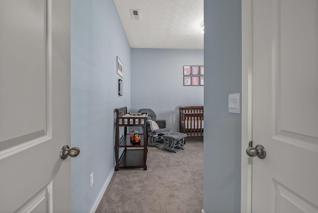 759 Abby Dr, Plain City, OH 43064 - bedroom with light carpet, a crib, a textured ceiling, and baseboards
