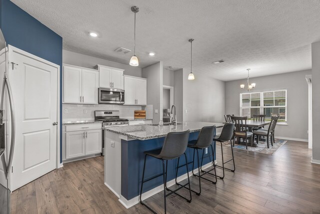 759 Abby Dr, Plain City, OH 43064 - kitchen with appliances with stainless steel finishes, tasteful backsplash, a textured ceiling, a sink, and white cabinets