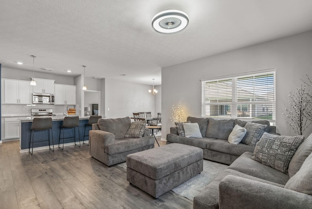 759 Abby Dr, Plain City, OH 43064 - living area with wood finished floors, a chandelier, and recessed lighting