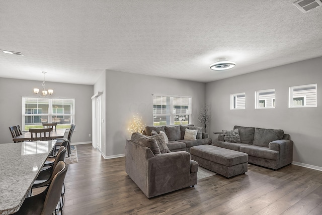 759 Abby Dr, Plain City, OH 43064 - living area with a chandelier, dark wood-style floors, baseboards, and a textured ceiling