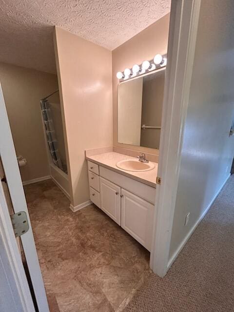 6855 Falcon Ln Unit 4A, Canal Winchester, OH 43110 - bathroom with an enclosed shower, vanity, a textured ceiling, and baseboards