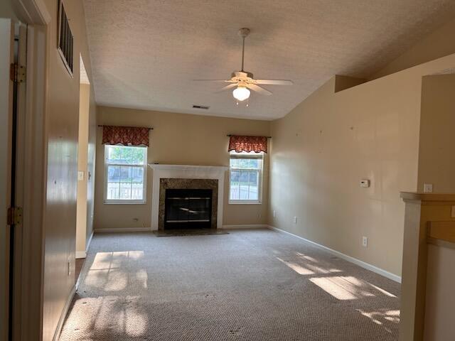 6855 Falcon Ln Unit 4A, Canal Winchester, OH 43110 - unfurnished living room with a premium fireplace, healthy amount of natural light, vaulted ceiling, a ceiling fan, and baseboards