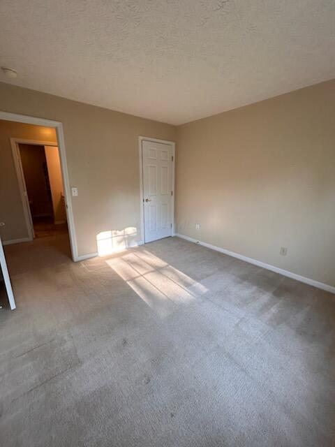 6855 Falcon Ln Unit 4A, Canal Winchester, OH 43110 - unfurnished room featuring carpet flooring, baseboards, and a textured ceiling