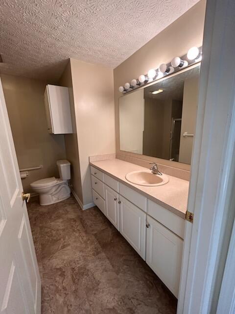 6855 Falcon Ln Unit 4A, Canal Winchester, OH 43110 - bathroom featuring vanity, toilet, and a textured ceiling