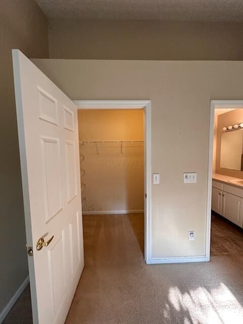 6855 Falcon Ln Unit 4A, Canal Winchester, OH 43110 - unfurnished bedroom featuring a walk in closet, carpet floors, baseboards, and a closet