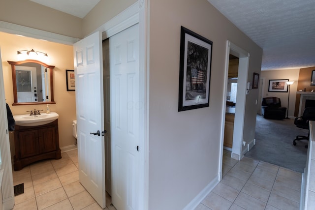 5392 Ponderosa Dr, Columbus, OH 43231 - hallway featuring a sink, light tile patterned floors, and baseboards