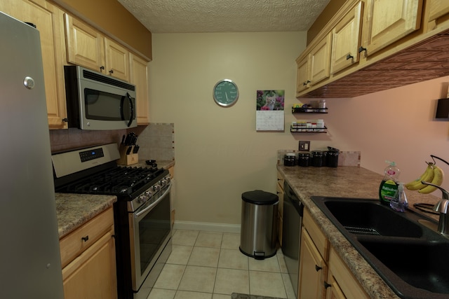 5392 Ponderosa Dr, Columbus, OH 43231 - kitchen with stainless steel appliances, a sink, backsplash, light tile patterned floors, and light brown cabinetry