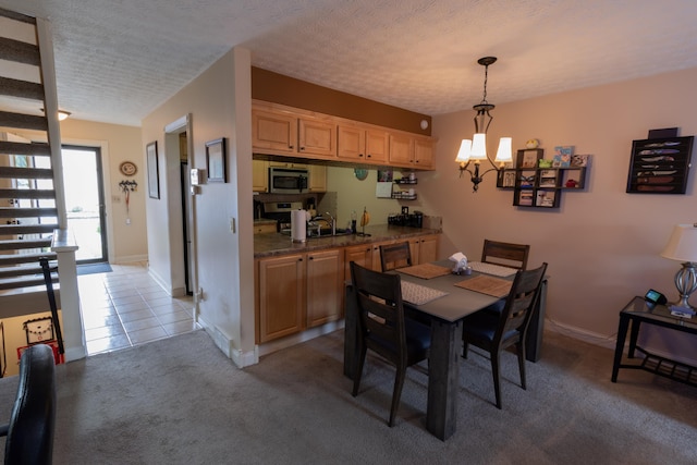5392 Ponderosa Dr, Columbus, OH 43231 - dining area featuring a chandelier, light carpet, baseboards, and a textured ceiling