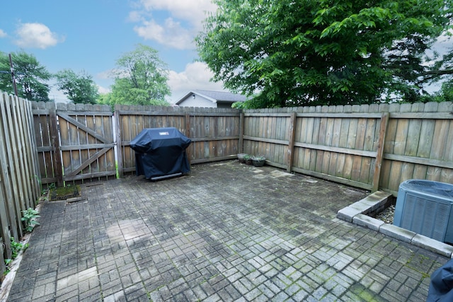5392 Ponderosa Dr, Columbus, OH 43231 - fenced backyard with central air condition unit, a grill, a patio area, and a gate