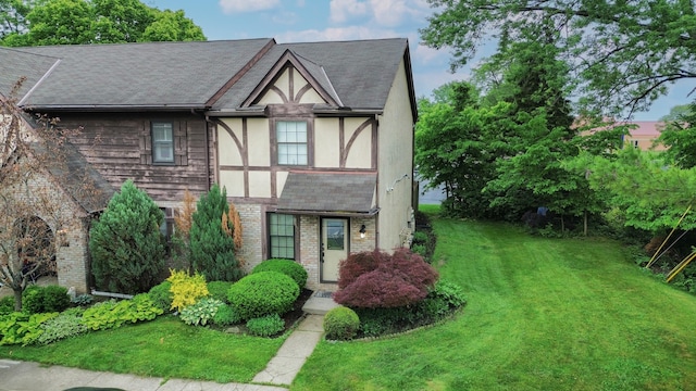 5392 Ponderosa Dr, Columbus, OH 43231 - tudor-style house with brick siding, stucco siding, a front lawn, and roof with shingles