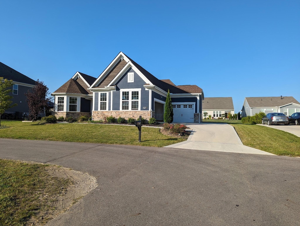 3677 Audubon Ave, Hilliard, OH 43026 - craftsman inspired home featuring a garage, a front lawn, concrete driveway, and stone siding