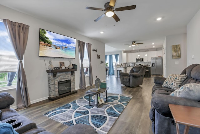 4196 Holstein Dr, Obetz, OH 43207 - living area featuring ceiling fan, wood finished floors, a stone fireplace, baseboards, and recessed lighting