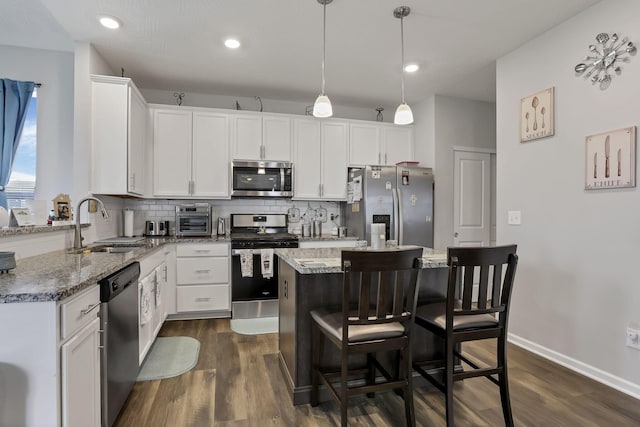 4196 Holstein Dr, Obetz, OH 43207 - kitchen with stainless steel appliances, a sink, tasteful backsplash, dark wood finished floors, and recessed lighting