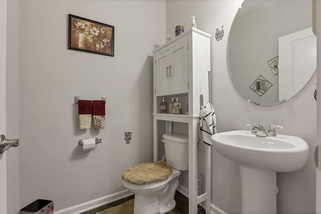 4196 Holstein Dr, Obetz, OH 43207 - half bath featuring toilet, a sink, and baseboards