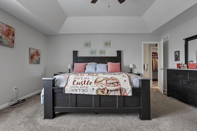 4196 Holstein Dr, Obetz, OH 43207 - carpeted bedroom featuring a raised ceiling, a walk in closet, baseboards, and a ceiling fan