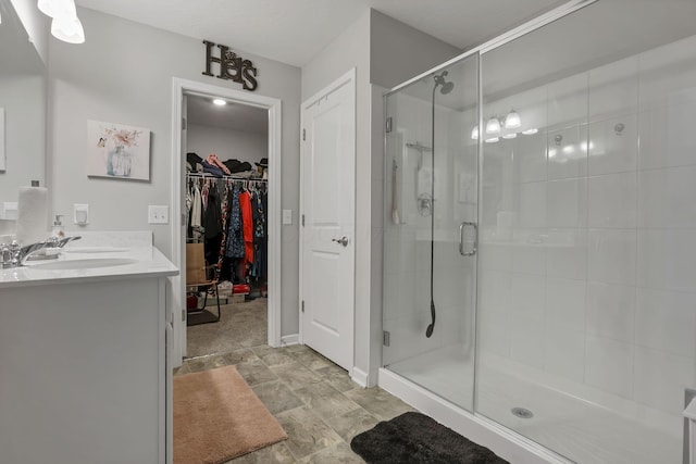 4196 Holstein Dr, Obetz, OH 43207 - bathroom with a shower stall, a walk in closet, double vanity, and baseboards