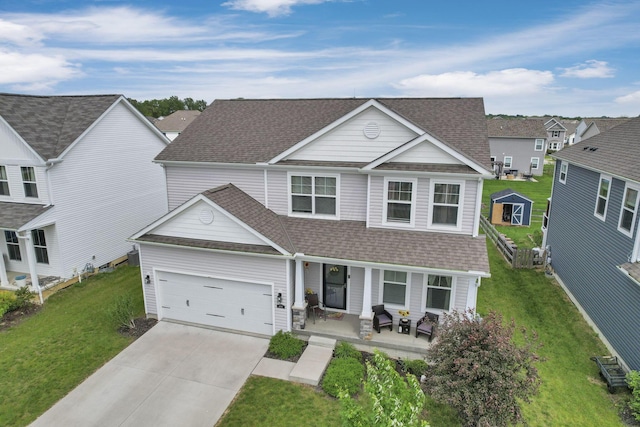 4196 Holstein Dr, Obetz, OH 43207 - traditional-style house featuring covered porch, roof with shingles, concrete driveway, a front lawn, and an attached garage