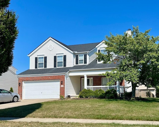 6004 Goldstone Dr, Grove City, OH 43123 - view of front of house with a porch, an attached garage, brick siding, and a front yard