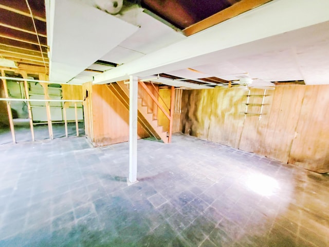 16251 State Route 678, Rockbridge, OH 43149 - unfinished basement with wood walls, stairway, and tile patterned floors