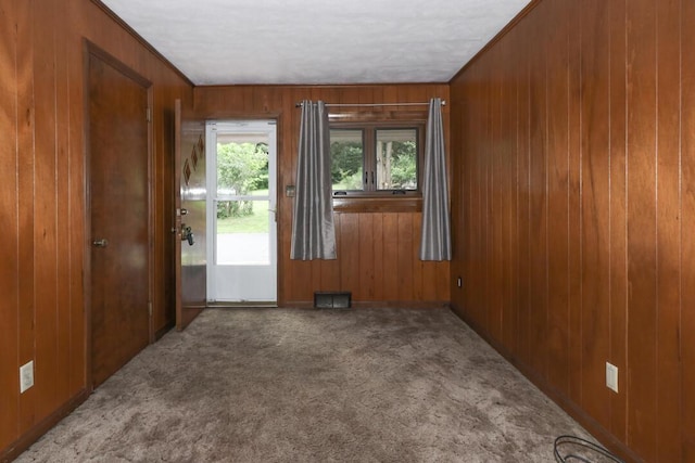 1266 Hanley Rd W, Mansfield, OH 44903 - carpeted empty room featuring wooden walls and crown molding