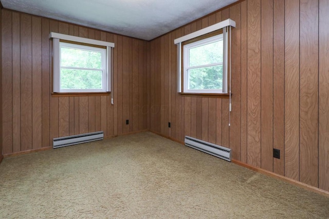1266 Hanley Rd W, Mansfield, OH 44903 - carpeted empty room featuring a baseboard radiator, plenty of natural light, and wooden walls