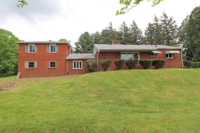 1266 Hanley Rd W, Mansfield, OH 44903 - view of front facade with a front lawn, brick siding, and a chimney