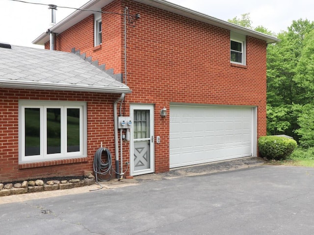 1266 Hanley Rd W, Mansfield, OH 44903 - view of front of property with driveway, brick siding, and an attached garage