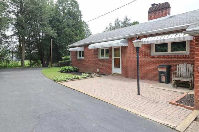 1266 Hanley Rd W, Mansfield, OH 44903 - rear view of house with brick siding and a chimney