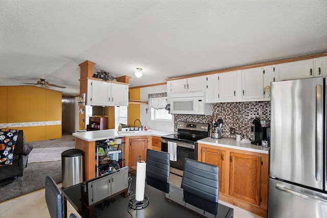 3200 Smeltzer Rd Unit 90, Marion, OH 43302 - kitchen featuring stainless steel appliances, light countertops, backsplash, a ceiling fan, and open floor plan
