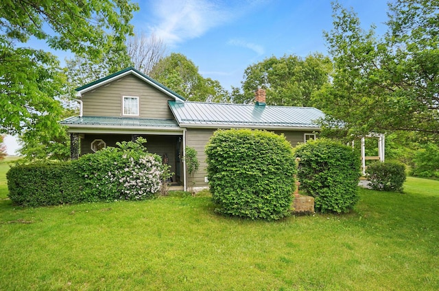 5870 Brook Rd NW, Baltimore, OH 43105 - view of front facade with a front lawn, a chimney, and metal roof