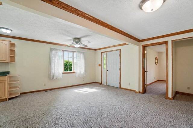 5870 Brook Rd NW, Baltimore, OH 43105 - unfurnished living room featuring light carpet, a textured ceiling, ceiling fan, baseboards, and ornamental molding