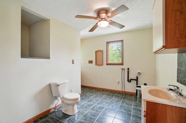 5870 Brook Rd NW, Baltimore, OH 43105 - bathroom with baseboards, toilet, ceiling fan, a textured ceiling, and vanity