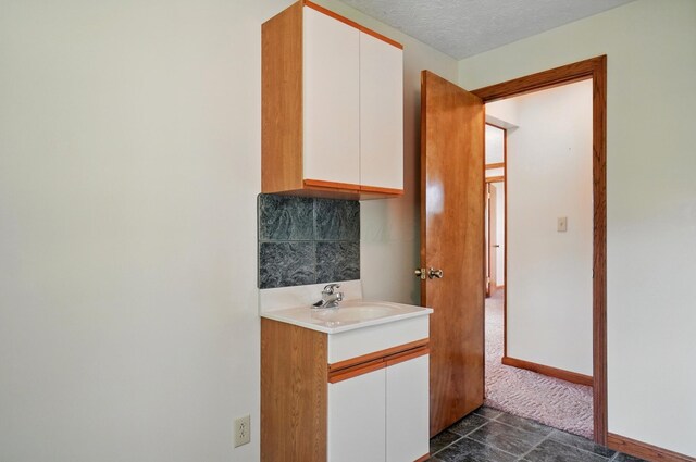 5870 Brook Rd NW, Baltimore, OH 43105 - bathroom featuring vanity, a textured ceiling, and baseboards