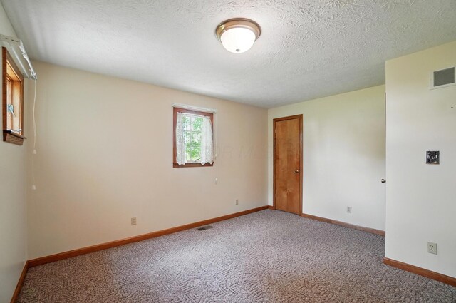 5870 Brook Rd NW, Baltimore, OH 43105 - unfurnished room with carpet flooring, baseboards, and a textured ceiling