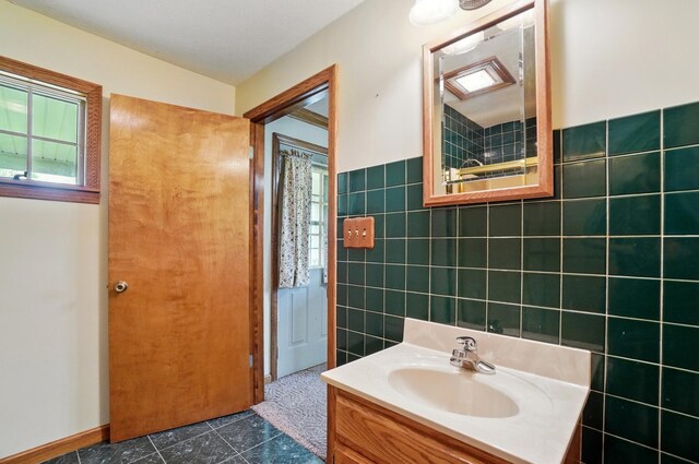 5870 Brook Rd NW, Baltimore, OH 43105 - bathroom featuring tile walls, plenty of natural light, vanity, and tile patterned floors
