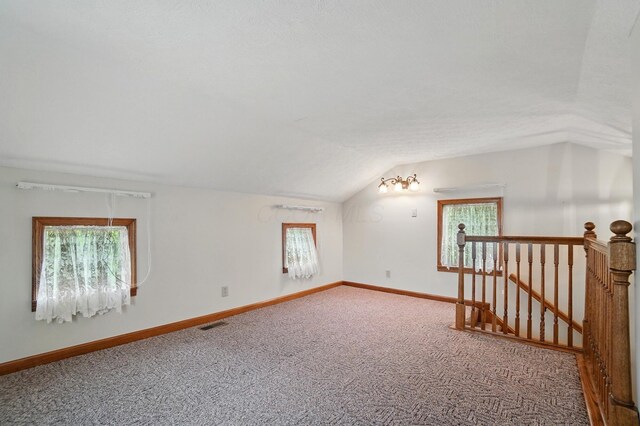5870 Brook Rd NW, Baltimore, OH 43105 - additional living space with vaulted ceiling, carpet floors, and baseboards