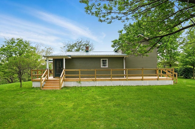 5870 Brook Rd NW, Baltimore, OH 43105 - rear view of property with a deck, a yard, metal roof, and a chimney