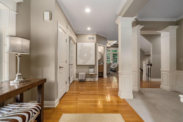 712 Riverbend Ave, Powell, OH 43065 - foyer entrance featuring ornate columns, light wood-style floors, ornamental molding, and recessed lighting