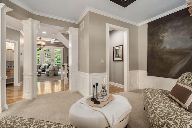 712 Riverbend Ave, Powell, OH 43065 - sitting room featuring ornate columns, crown molding, light colored carpet, a chandelier, and light wood-style flooring