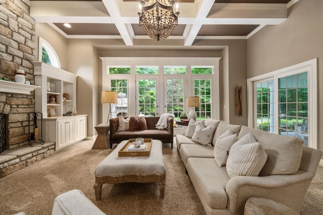 712 Riverbend Ave, Powell, OH 43065 - living area with light colored carpet, a chandelier, beam ceiling, crown molding, and a stone fireplace