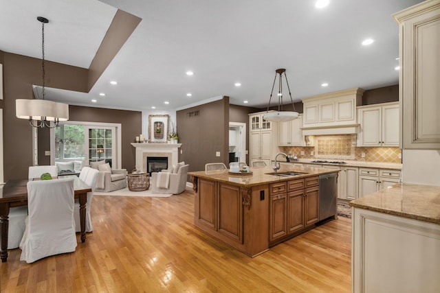 712 Riverbend Ave, Powell, OH 43065 - kitchen with cream cabinets, a sink, stainless steel appliances, light stone counters, and recessed lighting