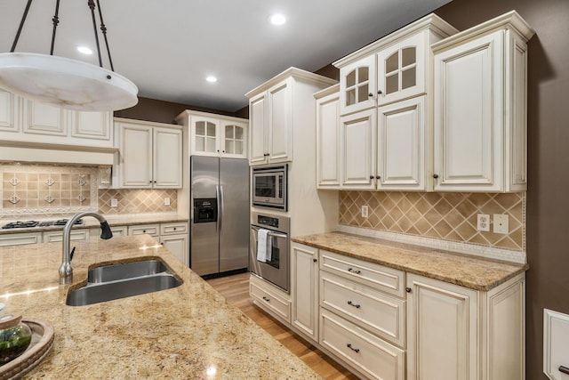 712 Riverbend Ave, Powell, OH 43065 - kitchen featuring appliances with stainless steel finishes, a sink, backsplash, recessed lighting, and light wood-type flooring