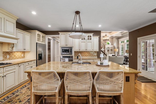 712 Riverbend Ave, Powell, OH 43065 - kitchen with appliances with stainless steel finishes, a sink, recessed lighting, light stone countertops, and glass insert cabinets