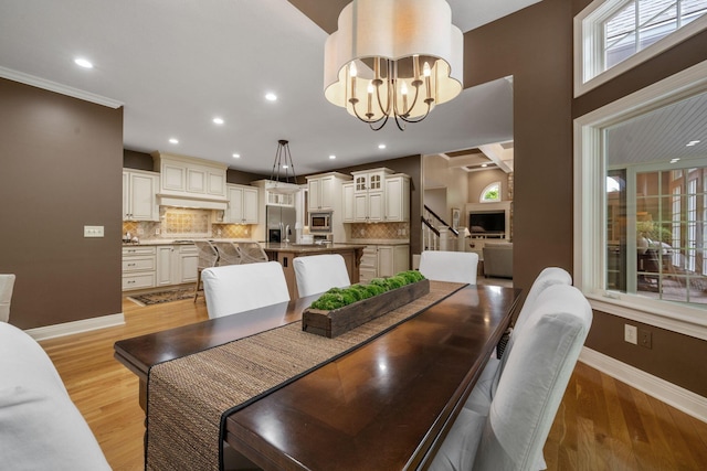 712 Riverbend Ave, Powell, OH 43065 - dining room with baseboards, a chandelier, light wood-style flooring, and recessed lighting