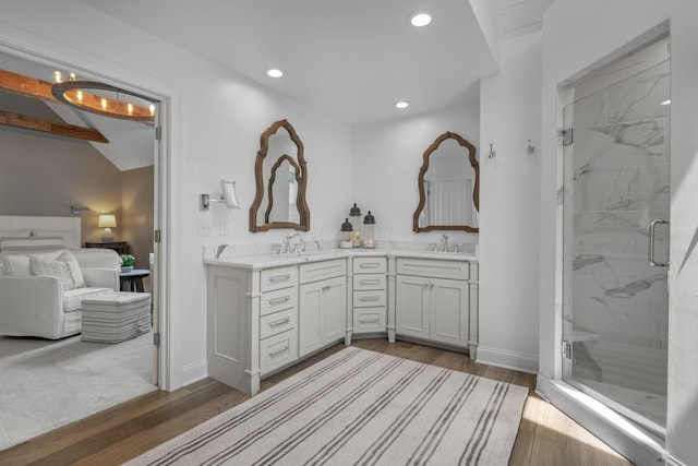 712 Riverbend Ave, Powell, OH 43065 - ensuite bathroom with a marble finish shower, double vanity, wood finished floors, recessed lighting, and baseboards